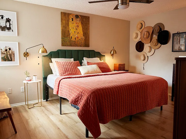 Bedroom featuring wood finished floors, a ceiling fan, and a textured ceiling