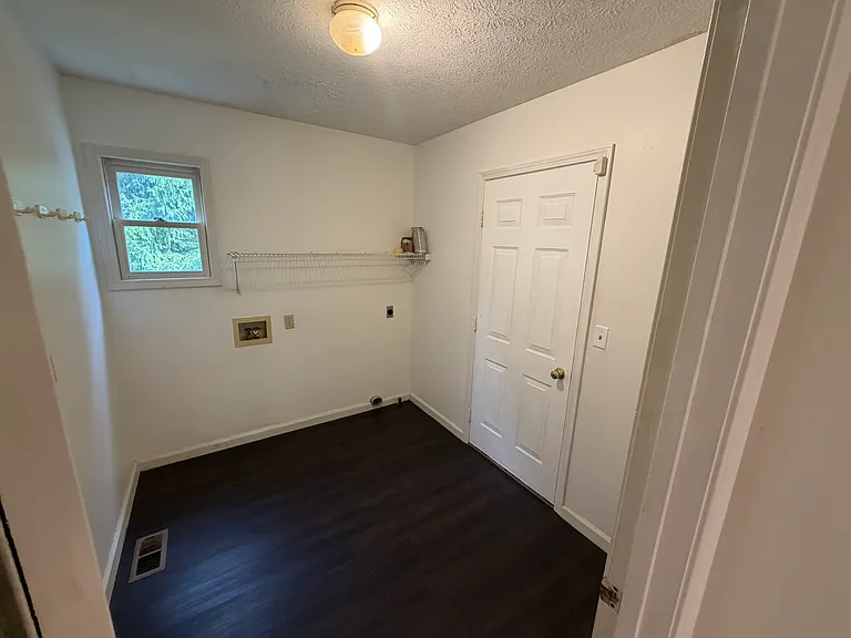 laundry room with electric AND natural gas dryer hookups, door to garage.
