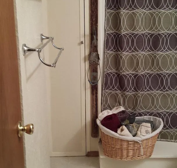 Entrance leading into a full bath. Tub, shower and sink. Toilet to tight of doorway.