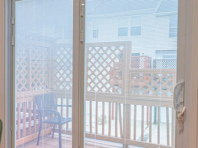 Sliding glass doors provide abundant natural light and seamless access to the private deck_perfect for indoor-outdoor living.