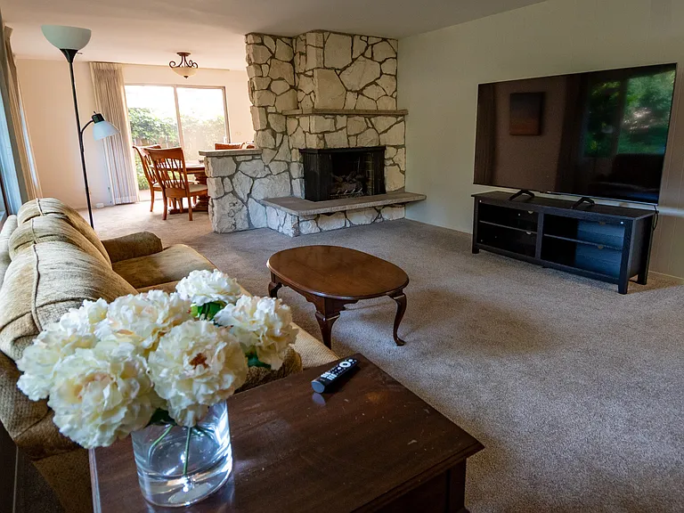 Furnished living room with 75" TV.