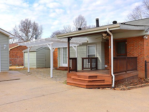 Back entry with deck and garden shed.