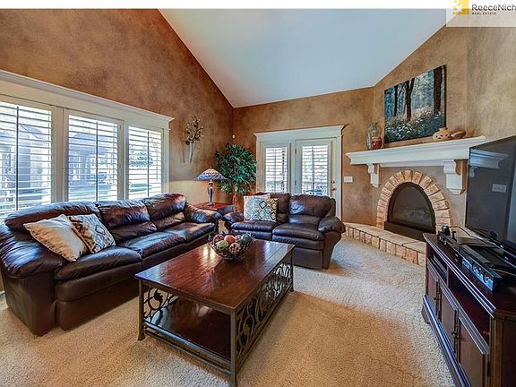 Great Room with Stone Trim, souring vaulted ceilings, and plantation shutters.