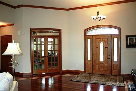Gleaming Brazilian Cherry hardwood floors with inlaid details throughout main level greet you at the
