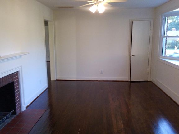 Spacious living area with bay window.