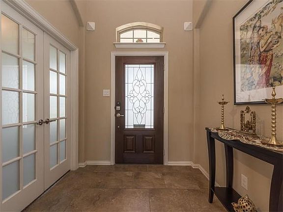 Beautiful entry with upgraded leaded glass door and numerous architectural features. The owner has a