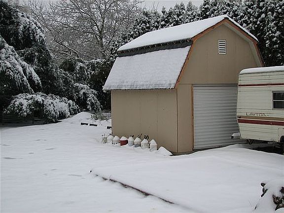 Backyard shop, garden space, parking, and patio