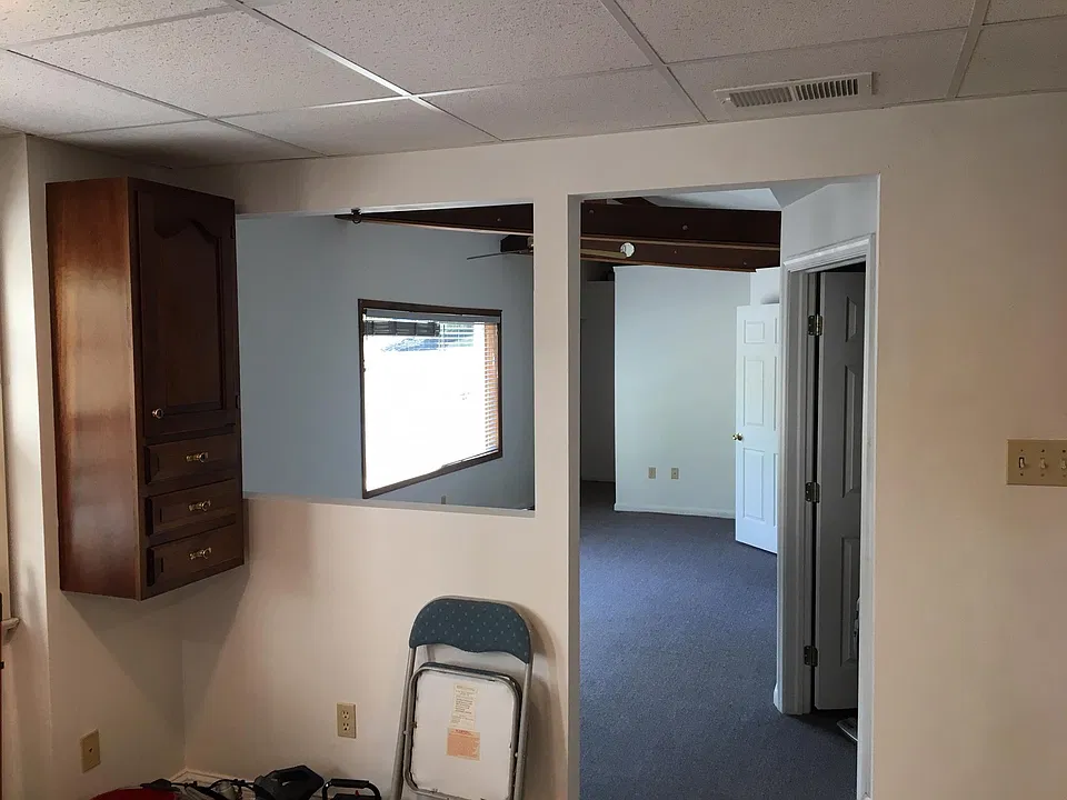 Looking from the kitchen toward the living room, both doors on the right are into the bedrooms