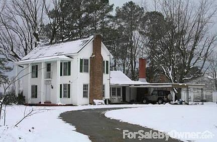 FRONT OF HOUSE - WINTERSCAPE
						:
						Right side has double carport feeding into extra large circular driveway