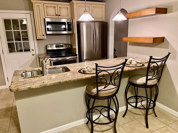 Granite Countertop Island and Stainless Appliances