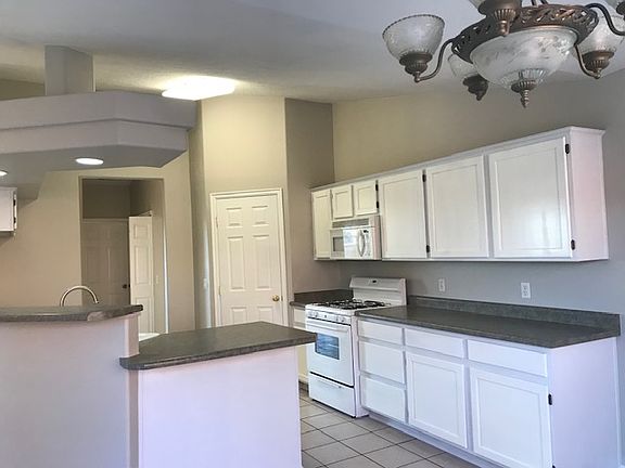 Kitchen with large walk in pantry, and wrap around breakfast bar.