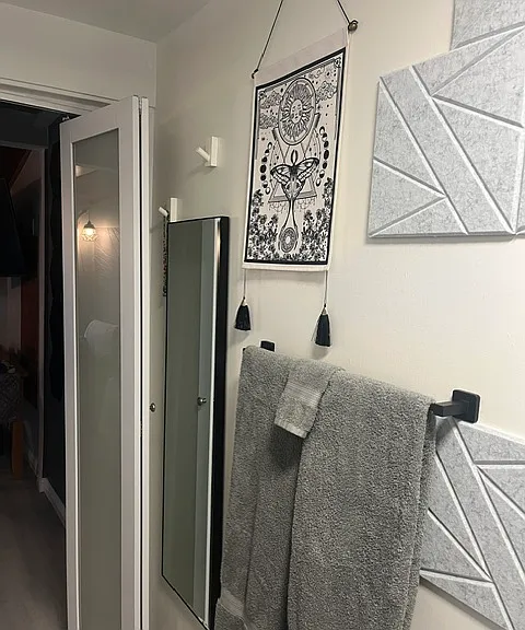 Towels and rack with hooks for rob etc. and a full length mirror.