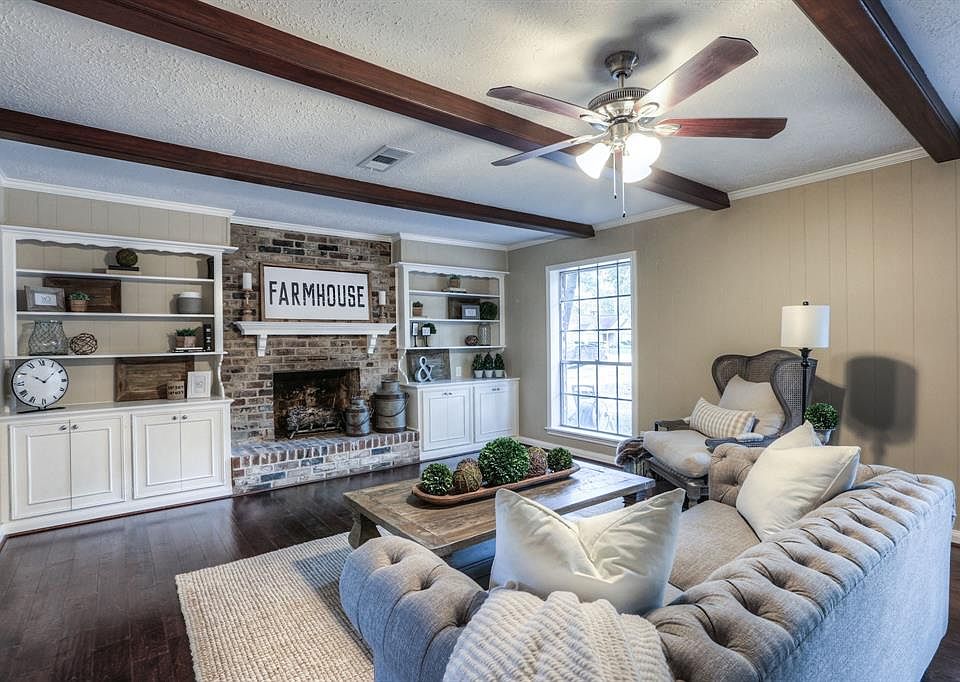 Who wouldn't want to call this living room Home with its beautiful wood flooring, brick gas fireplace and site-built cabinets!