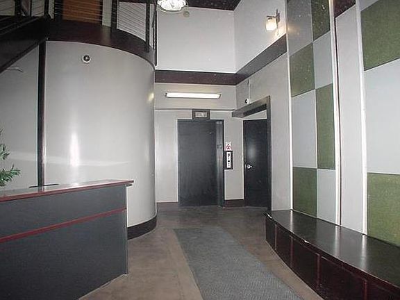 Lobby with view of the elevator. The secure door to the covered garage is to the left and secure door to street behind.