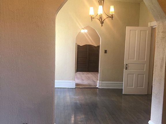 Dining room, kitchen brown doors and white door to bedroom on the right