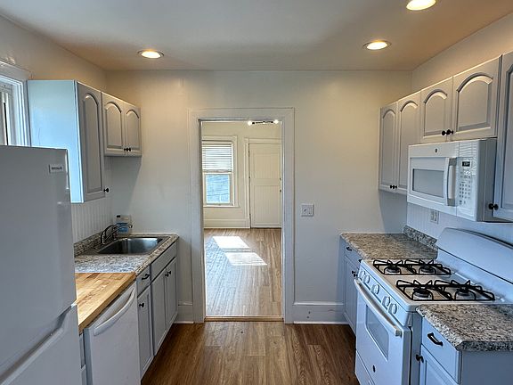 Kitchen features: dishwasher, oven, stovetop, microwave, sink, and brand new refrigerator/freezer.