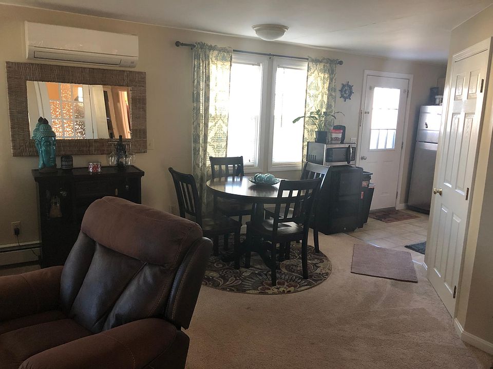 Other side of living room. Can be used as a dining room or just expanded living room space. This leads to kitchen and back deck. More windows to let in lots of light. Split unit central air conditioning installed 2 years ago to keep you cool on the warmes