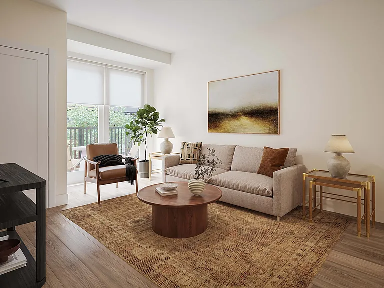 Elegant living room with a cozy beige sofa, chic armchair, and stylish decor, bathed in natural light from large windows.