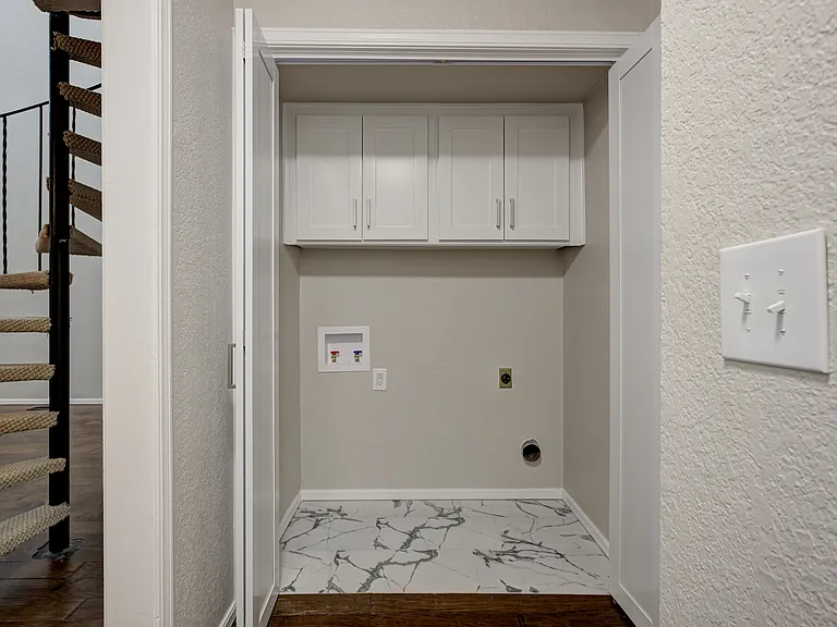 Laundry area with bifold doors next to bedroom 2.