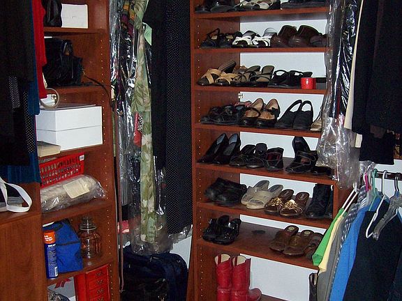 Master suite has oversized walk in closet with custom shelves and cabinetry