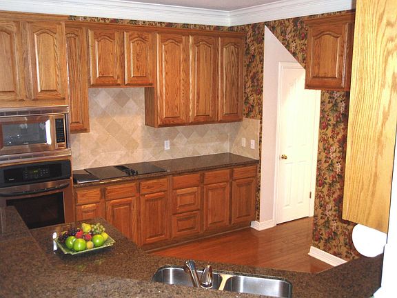 Kitchen upgraded with stainless steel appliances and granite counter tops.