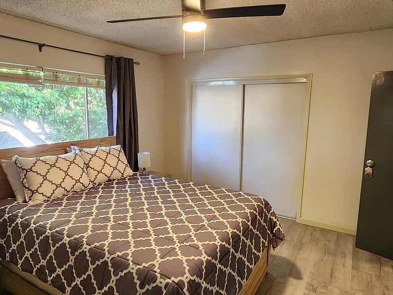 West facing bedroom with large window, blinds and blackout curtains
