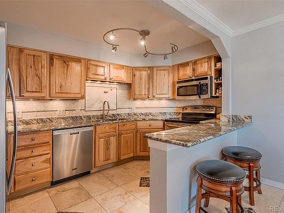 Granite countertops, tile backsplash, stainless steel appliances.