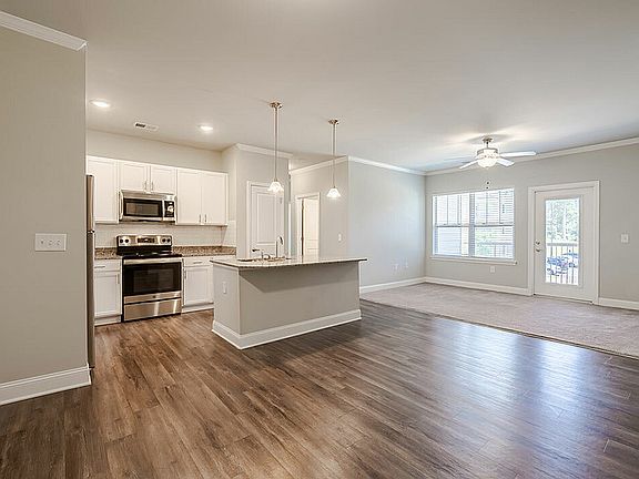 Experience modern elegance in this open-concept living space with a stylish kitchen and abundant natural light.