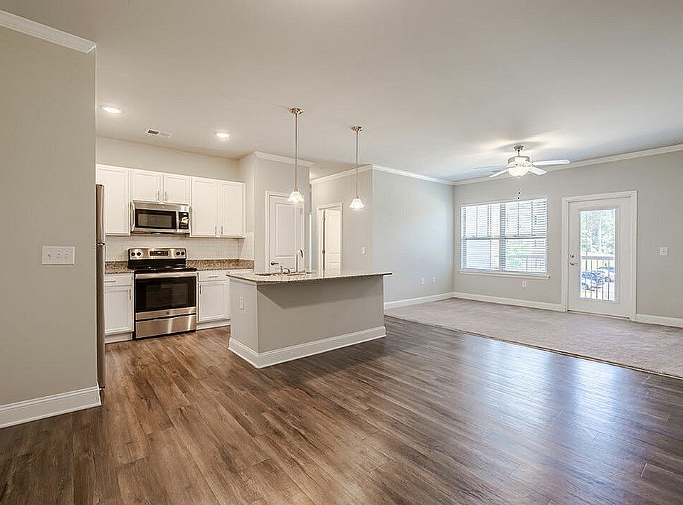 Experience modern elegance in this open-concept living space with a stylish kitchen and abundant natural light.