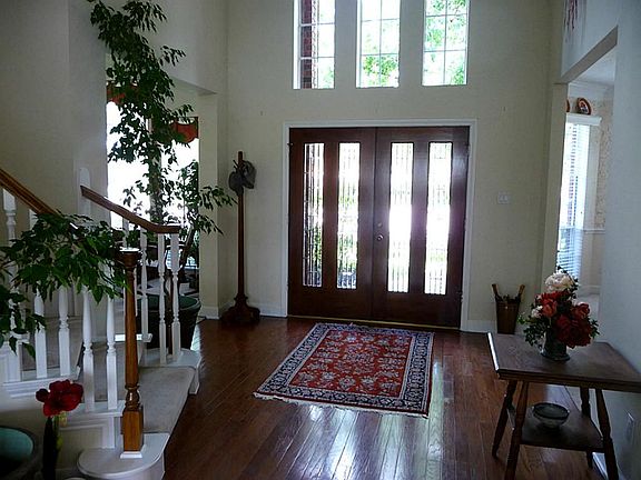 Foyer greets you as it opens on to Wood floors, lots of windows and beautifully decorated.