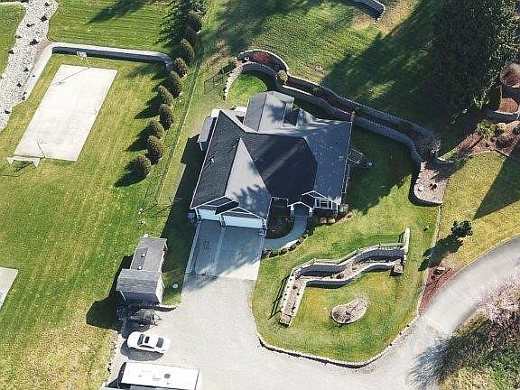 Overhead view you can see all the features of this property. Covered RV parking, garden space, storage sheds, terraced and landscaping.