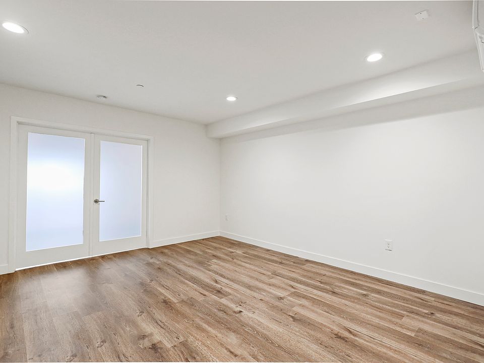 Large Bedroom with Double Doors, Recess Lighting, and Vinyl Wood Flooring