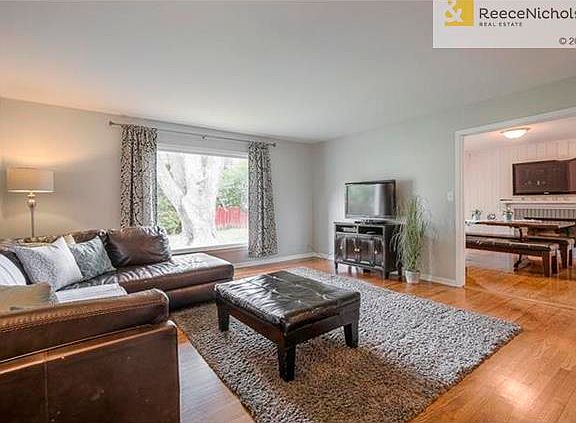 Large living room has beautiful new paint, hardwood floors and opens to dining/hearth room.
