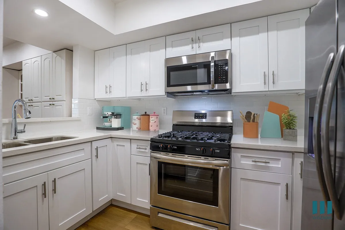 Kitchen with Energy-Efficient Appliances and Ample Cabinet Storage - Rose Flower by Wiseman