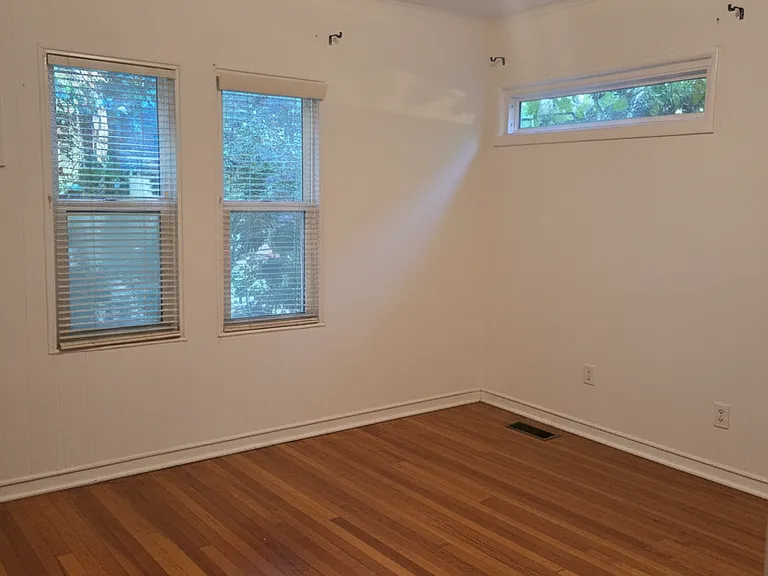 Front main bedroom with half bath and a built in closet and shelves (not seen in this picture)