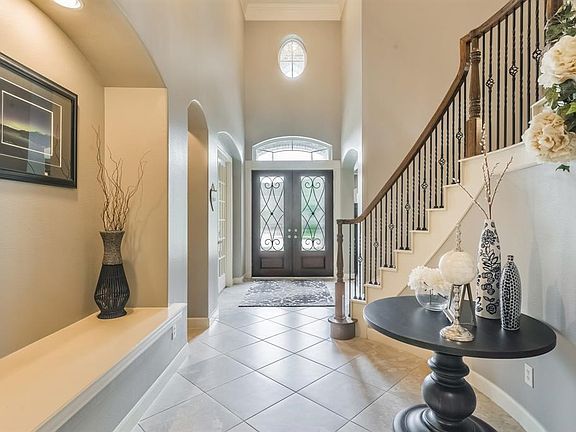 2-story Entry welcomes you home through double doors