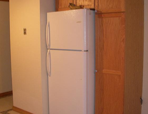 One side of eat in kitchen with utility closet