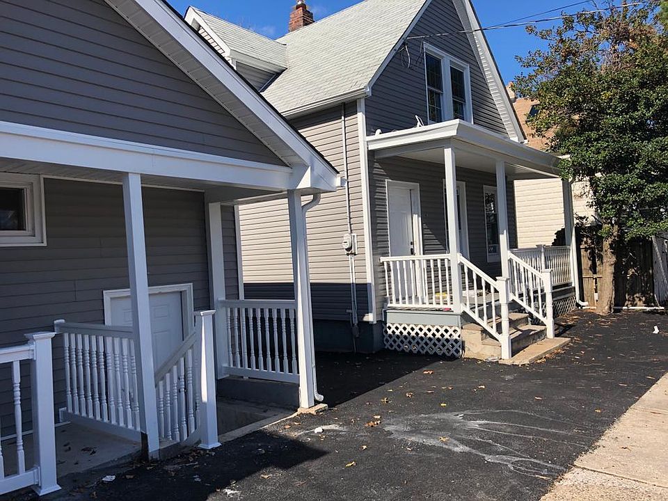 Front of house, Middle of the houses is the driveway to pull into backyard parking.