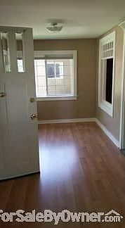 Front porch : Enclosed with vinyl plank flooring & large windows with energy efficient blinds