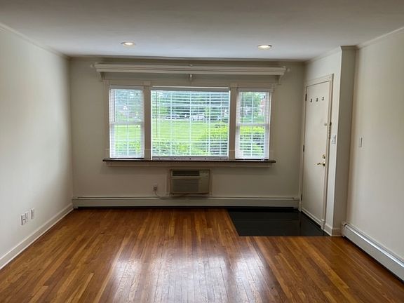 Living Room w/natural light and beautiful hardwood floors.