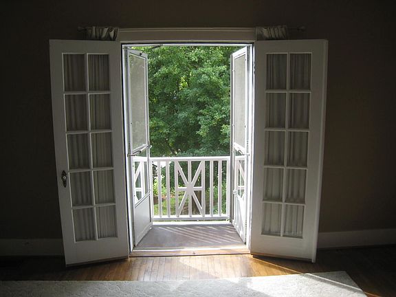 This is in the living room, with a very small, personal balcony