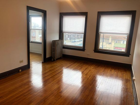 Natural wood floors. New taupe colored roller shades