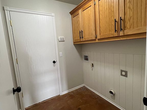 Inside laundry room with storage