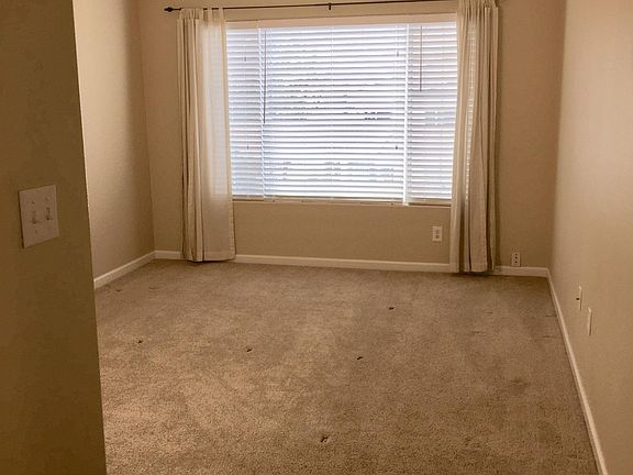 Primary bedroom big enough for a king, with ceiling fan