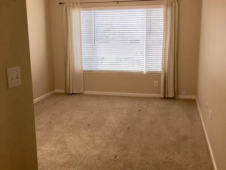 Primary bedroom big enough for a king, with ceiling fan