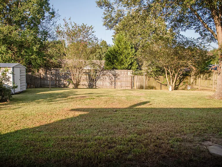 Fully Fenced backyard with storage shed
