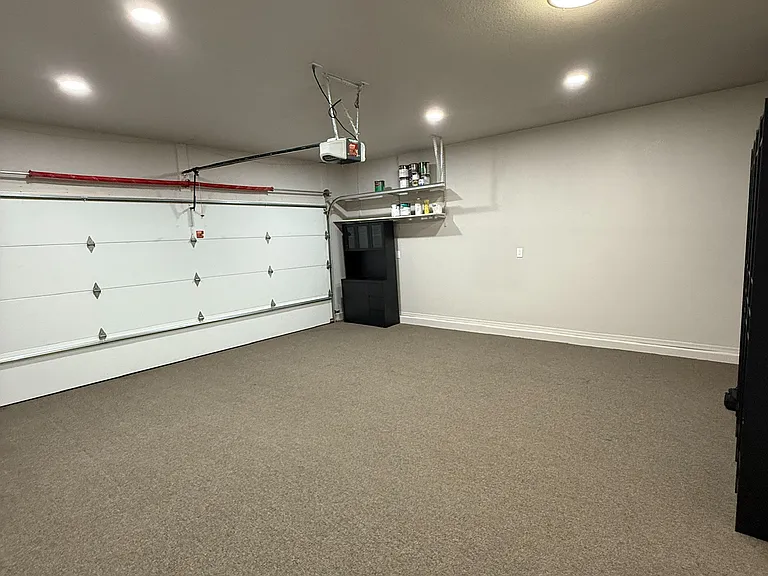 Attached two-car garage with additional storage space.