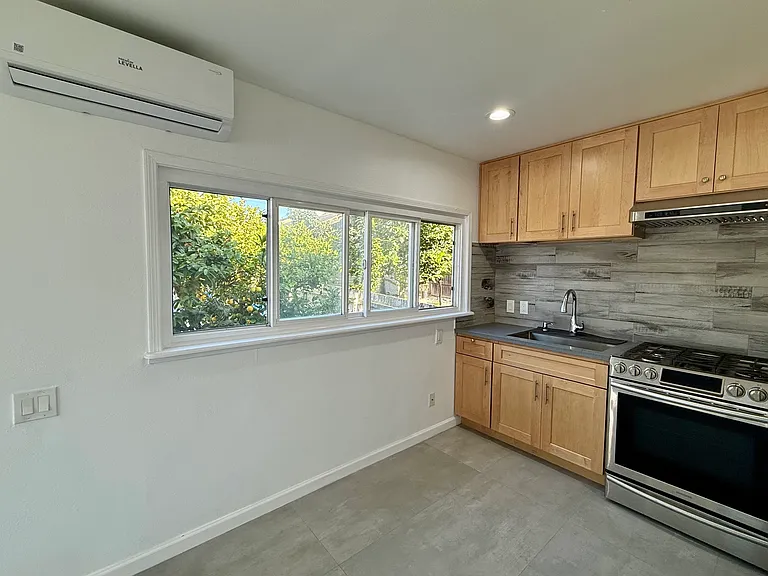 Kitchen with brand new air conditioning/heating unit shown.