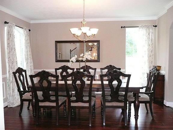 Formal dining room with wood flooring and 2 large windows.