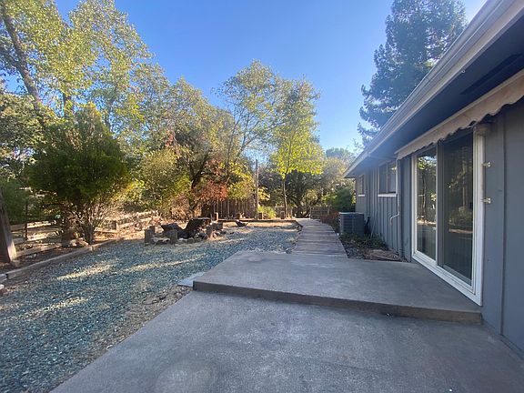 Side yard with patio space and garden area